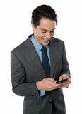 Happy businessman using a mobile phone