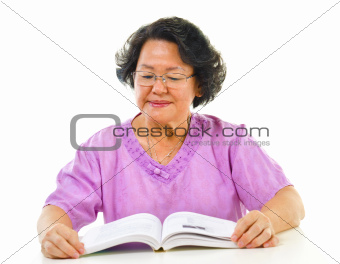 Asian senior woman serious reading