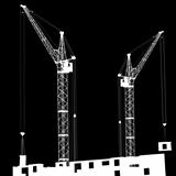 Silhouette of two cranes working on the building 