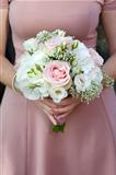bridesmaid holding a wedding bouquet of pink flowers