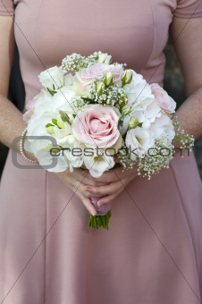 bridesmaid holding a wedding bouquet of pink flowers