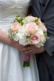 bride and groom hold wedding bouquet