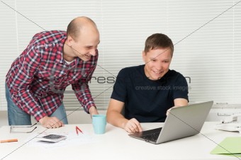 two casual people discuss the new project at office