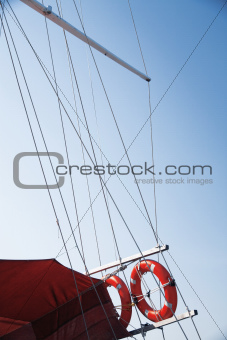 red lifebuoy of ship on a background a blue sky