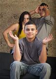 Grinning Young Man with Angry Parents