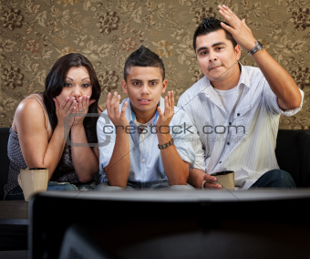 Shocked Hispanic Family Watching TV