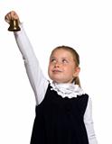 Young school girl ringing a golden bell on an outstretched arm o