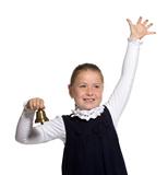 Young school girl ringing a golden bell on white background 