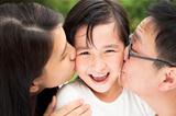 happy asian family in kissing
