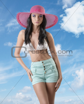 sexy brunette with shorts and hat is in front of the camera