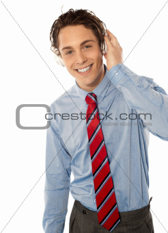 Relaxed young smiling male listening to music