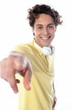 Guy with headphones pointing at you