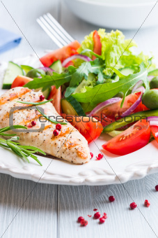 Grilled chicken fillet with salad on a plate