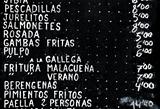 list of spanish dishes written on a blackboard