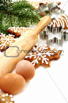 Christmas ginger biscuits, eggs, rolling pin and dough forms.