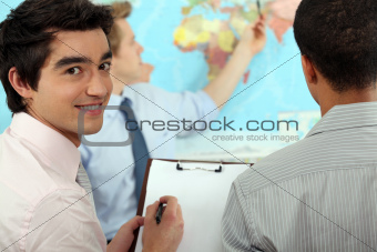 Young businessman discussing a map