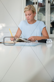 Young woman checking bills and doing budget at home