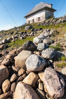 Stone house on the rocky shore.