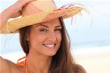 Woman on the beach with straw hat