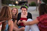 Hispanic Teen with Friends and Phone