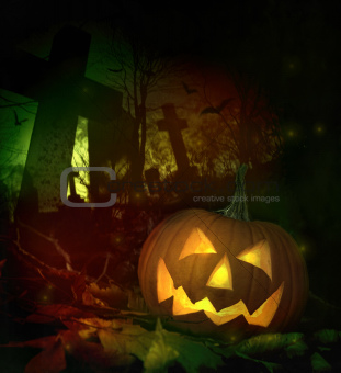 Halloween pumpkin in spooky cemetery