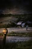 Eerie night scene with Halloween pumpkin on fence