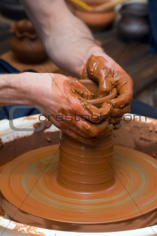 potter makes a jug out of clay