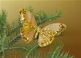 Christmas decoration (golden butterfly) on the branches of fir