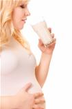 Pregnant woman with a glass of milk drink
