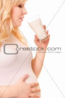 Pregnant woman with a glass of milk drink