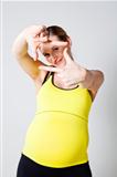 Pregnant woman making a frame