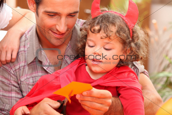 Little boy and his father preparing Halloween party