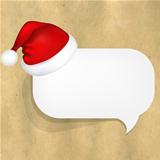 Cardboard Structure With White Paper Speech Bubble And Santa Hat