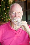 Senior Man Enjoys a Glass of Wine