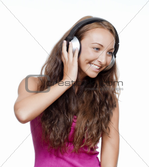 young girl listening to music in earphones smiling - isolated on white