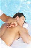 Woman Having Massage By Pool At Health Spa