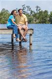 Romantic Man and Woman Couple Sitting By Lake