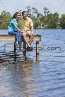 Romantic Man and Woman Couple Sitting By Lake