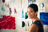 Portrait of happy hispanic young woman working as fashion design