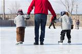 Family having fun at the skating rink