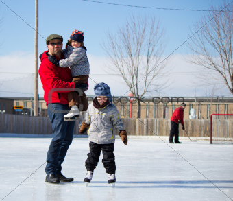 Happy family at the skating rink