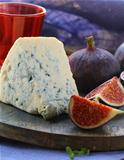 blue cheese and sweet fruit  figs on a wooden board
