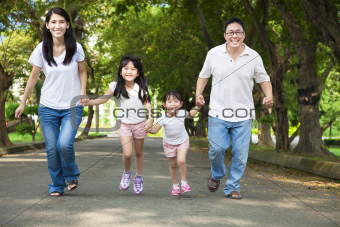 happy asian family walking on the road