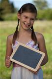 Young girl holding a small blackboard