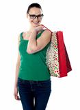 Smiling young female carrying shopping bags