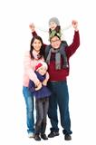 full length of happy asian family in winter clothes standing tog
