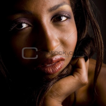 Dark female model looking interested