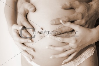 4 hands on pregnant belly