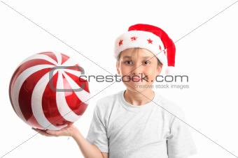 Child holding a large bauble