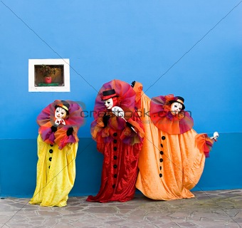 Three white clowns in mask performing